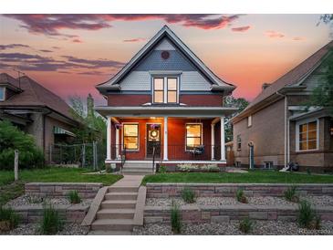 Charming home with a covered porch and a beautifully landscaped front yard at sunset at 3008 N York St, Denver, CO 80205