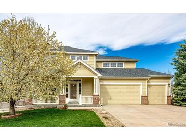 Charming two-story home featuring a well-manicured lawn and an attached two-car garage at 4157 Astrion Ct, Castle Rock, CO 80104