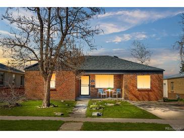 Charming brick home with a well-manicured lawn, inviting entrance, and cozy outdoor seating area at 4563 W 34Th Ave, Denver, CO 80212