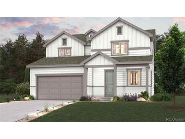 Charming two-story home with a two car garage and a beautifully landscaped front yard at 1417 Bloom St, Brighton, CO 80601