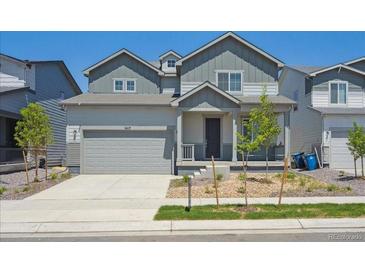 Charming two-story home with a well-maintained lawn, garage, and welcoming front porch at 1417 Bloom St, Brighton, CO 80601