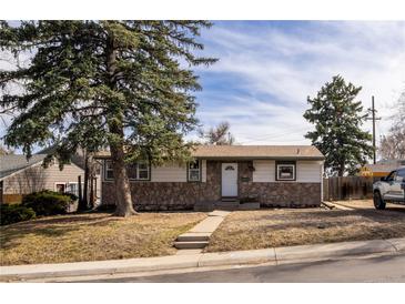 Charming single-story home with stone accents, landscaped front yard, and mature trees in established neighborhood at 780 Campo St, Denver, CO 80221