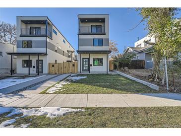 Modern two-story home featuring a balcony, manicured lawn, and contemporary design elements at 1715 Grove St, Denver, CO 80204