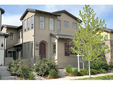 Charming two-story home with neutral stucco exterior and landscaped front yard at 15525 W La Salle Ave, Lakewood, CO 80228