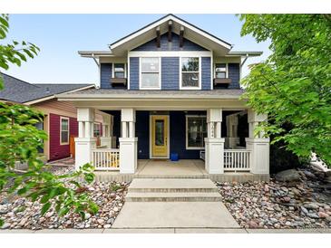 Charming two-story home boasts a welcoming front porch and beautiful landscaping, creating great curb appeal at 3644 Wabash St, Denver, CO 80238