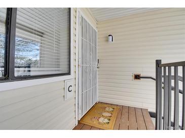 Inviting entryway with secure door, welcome mat, and natural light from the window with blinds at 7835 Barbara Ann Dr # C, Arvada, CO 80004
