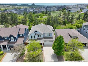 Charming two-story home boasts a well-manicured front yard and a two-car garage in a desirable neighborhood at 1271 Sky Rock Way, Castle Rock, CO 80109