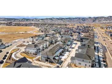 Community aerial view shows modern homes in a well-planned neighborhood with mountain views at 8055 Navajo River Loop # B, Littleton, CO 80125