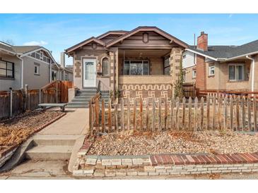 Charming bungalow with brick accents, covered porch, and inviting curb appeal at 1561 Newton St, Denver, CO 80204