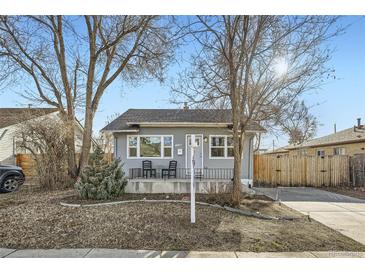 Charming single-story home with a cozy front porch and well-maintained yard at 1548 Ulster St, Denver, CO 80220