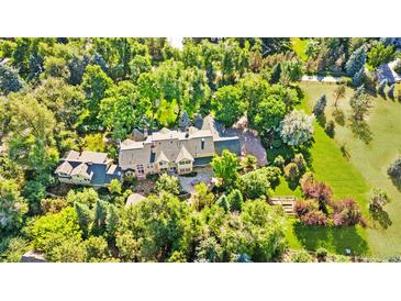 Stunning aerial view of estate home surrounded by lush trees and landscaped grounds at 1700 E Tufts Ave, Cherry Hills Village, CO 80113