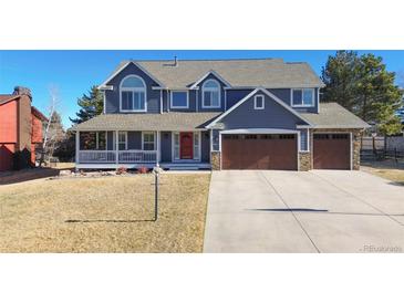 Charming two-story home featuring a covered porch, well-manicured lawn, and a convenient two-car garage at 6526 N Windfield Ave, Parker, CO 80134