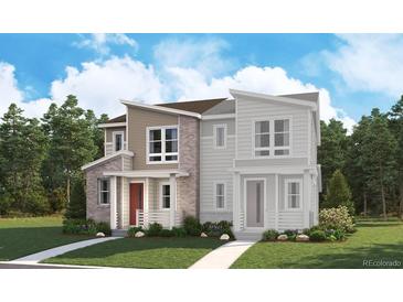 Charming two-story home with a combination of stone, siding and decorative brick, set against a backdrop of lush greenery at 1224 Penner Dr, Erie, CO 80026