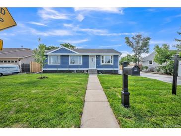 Charming blue home with a well-maintained front yard and inviting walkway at 7810 Larkwood St, Commerce City, CO 80022
