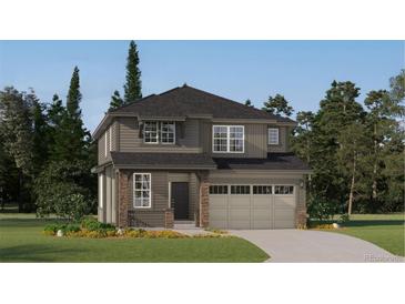Charming two-story home with stone accents, a two-car garage and professionally landscaped front yard at 10976 Snowdon St, Parker, CO 80134