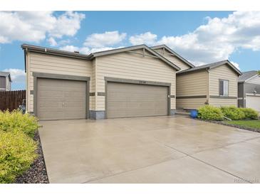 Charming home featuring a two-car garage and a well-maintained front yard with mature landscaping at 2328 Saddle Back Ct, Fort Lupton, CO 80621