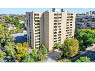 An exterior view of a high-rise building with private balconies surrounded by mature trees and city views at 800 N Pearl St # 303, Denver, CO 80203