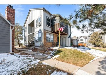 Charming townhouse showcasing a balcony, neat landscaping, and a welcoming entrance at 17118 E Whitaker Dr # E, Aurora, CO 80015