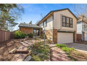 Charming two-story home with brick accents and a beautifully landscaped front yard at 12008 E Amherst Pl, Aurora, CO 80014