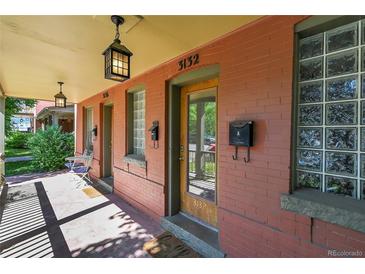 Inviting front porch featuring updated lighting, a glass block window, and access to the front door at 3132 Umatilla St # B, Denver, CO 80211