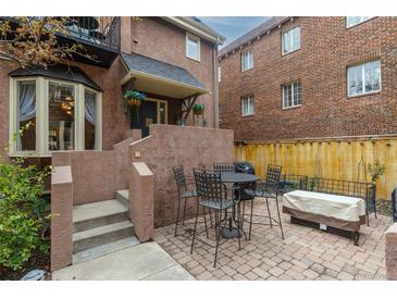 Inviting outdoor patio area with brick pavers, perfect for entertaining or relaxing with a table, chairs, and seating at 999 N Emerson St # 9, Denver, CO 80218