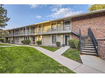 Charming condo complex with well-maintained lawn, mature trees, and individual balconies at 6495 E Happy Canyon Rd # 79, Denver, CO 80237