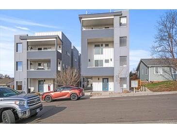 Modern, multi-story townhomes with sleek gray and white exteriors, complemented by well-maintained landscaping at 1245 Utica St # 105, Denver, CO 80204
