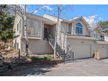 Charming home featuring multiple stories, stairs to the front door, and an attached two car garage at 28110 Meadow Dr, Evergreen, CO 80439