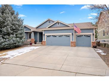Charming two-story home featuring a well-manicured front yard and an attached two-car garage at 1668 Rosemary Dr, Castle Rock, CO 80109