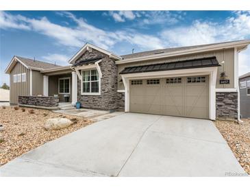 Beautiful exterior view of the home showcasing stone accents, garage, and well-maintained landscaping at 6657 S Kline Way, Littleton, CO 80127