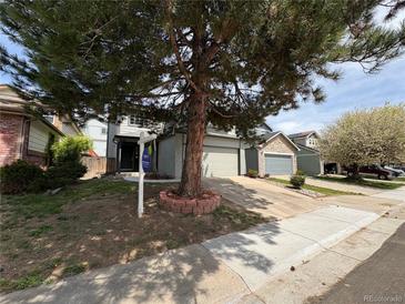 Charming two-story home with attached garage and mature tree in the front yard at 8034 Decatur St, Westminster, CO 80031