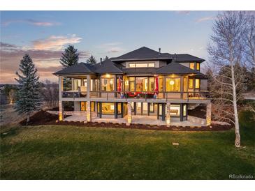 Stunning multi-story home featuring a spacious deck, stone accents, and well-maintained landscaping at 5602 Silver Bluff Ct, Parker, CO 80134