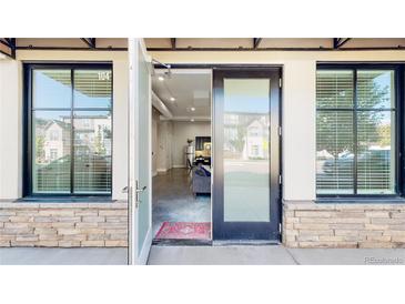 Inviting front entrance featuring a modern glass door and large windows for natural light with stone accents at 615 24Th St # 104, Golden, CO 80401