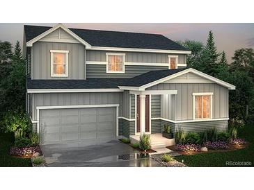 Charming two-story home featuring a gray facade, a two-car garage, and well-maintained landscaping at 267 Marlowe Dr, Erie, CO 80516
