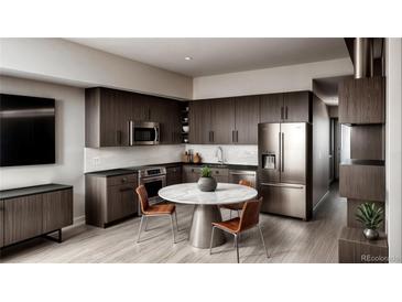Modern kitchen features stainless steel appliances, dark wood cabinets, and a marble table at 1643 Boulder St # 209, Denver, CO 80211