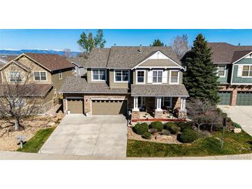 Beautiful two-story home featuring a stone facade, large driveway, and well-maintained landscaping at 4307 Lily Gulch Trl, Castle Rock, CO 80109