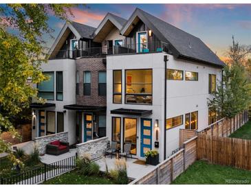 Modern two-story home with a mix of brick and white walls, and a fenced yard at 2257 S High St, Denver, CO 80210