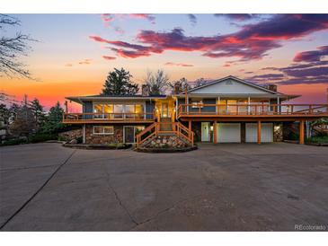 Stunning exterior of a two-story home with a spacious deck and a beautifully landscaped front yard at sunset at 8090 Newton St, Westminster, CO 80031