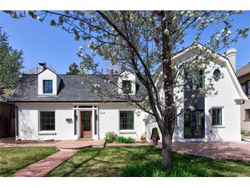 Charming home featuring a brick pathway leading to a beautifully maintained front yard at 2025 Ash St, Denver, CO 80207