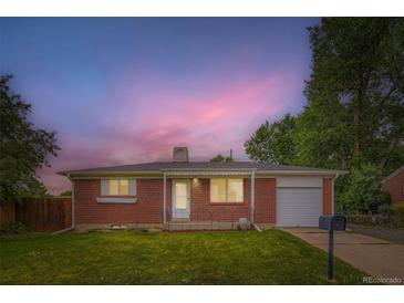 Charming single story brick home with a well-maintained lawn and an attached one car garage at 11891 Gaylord Way, Northglenn, CO 80233
