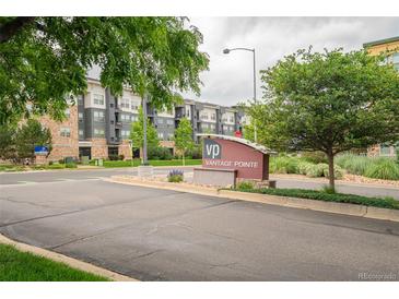 View of the Vantage Pointe community entrance sign with lush landscaping and modern residential buildings in the background at 13456 Via Varra # 225, Broomfield, CO 80020