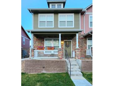 Charming two-story home with a stone facade, covered porch, and flower boxes for added curb appeal at 13640 Garfield St # A, Thornton, CO 80602