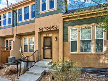 Inviting townhouse entrance with a charming front door and well-maintained landscaping at 5822 S Van Gordon Ln, Littleton, CO 80127