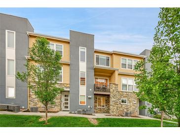 Stylish multi-level condo featuring stone accents, modern gray accents, and a charming balcony at 6745 S Tempe Ct, Aurora, CO 80016
