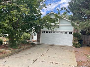 Ranch style home with attached garage and mature landscaping at 3674 S Flanders St, Aurora, CO 80013
