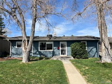 Charming single-story home with a well-maintained lawn and mature trees in a peaceful neighborhood at 4731 S Acoma St, Englewood, CO 80110