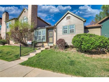 Charming multi-level home with a well-maintained front lawn and inviting entryway at 17325 E Rice Cir # F, Aurora, CO 80015