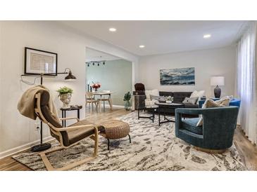 Bright living room boasts stylish furnishings and an open layout, creating an inviting and modern space at 3376 Jasmine St, Denver, CO 80207