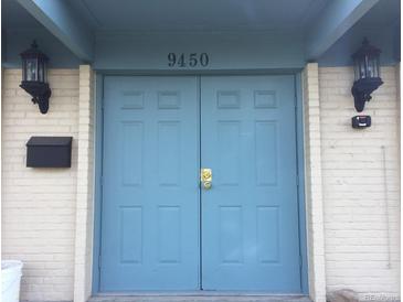 Image of the home's front double-doors with an address of 9450 and white-painted brickwork at 9240 E Girard Ave # 1, Denver, CO 80231