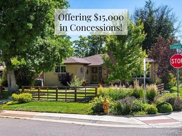 Charming single-story home with a well-manicured front yard and mature trees, offering $15,000 in concessions at 1594 S Locust St, Denver, CO 80224